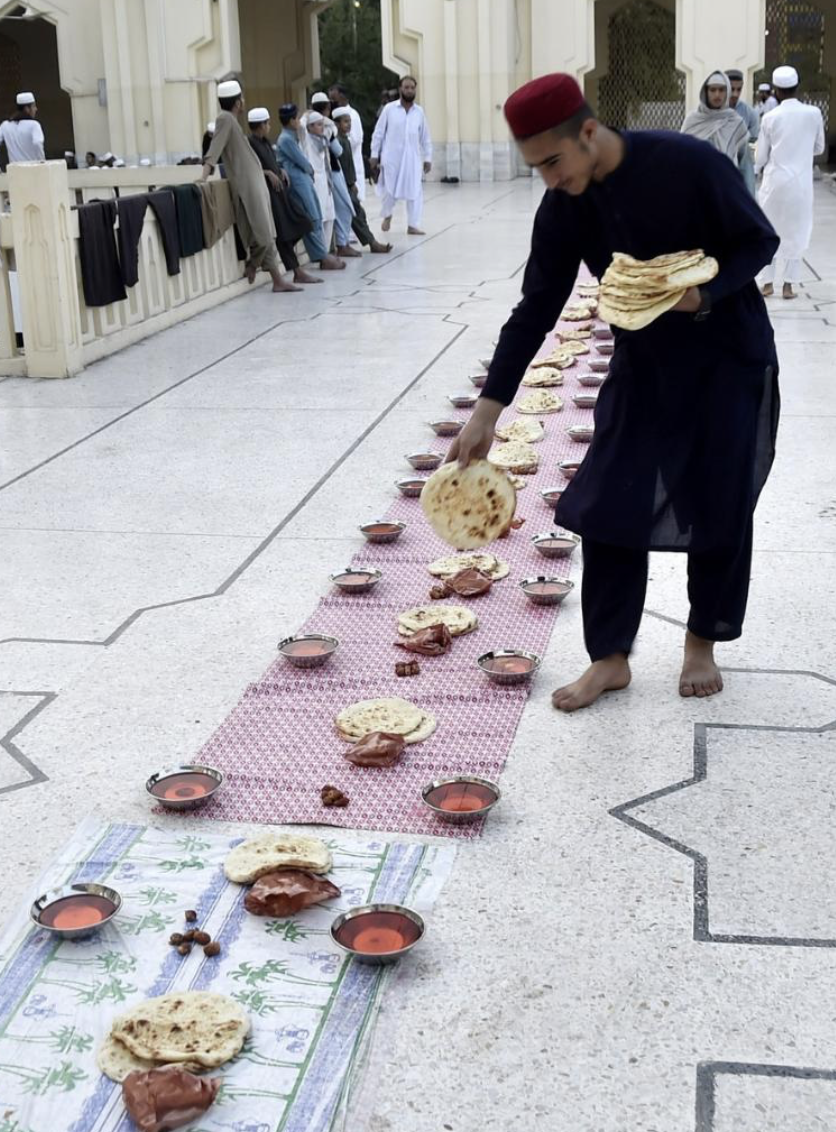 People gather to break the fast at a local mosque.